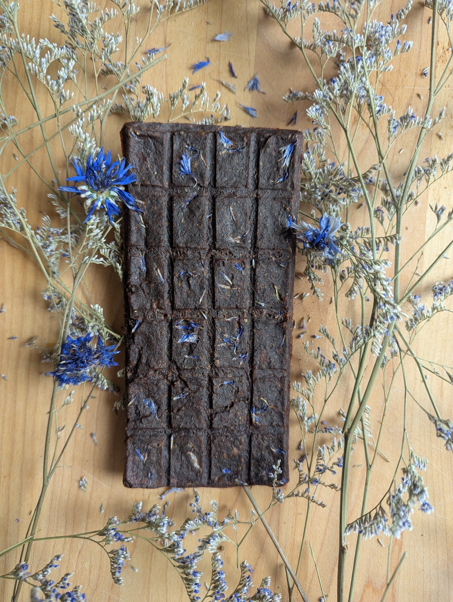 a dog treat with pork and blue cornflower in a chocolate bar 